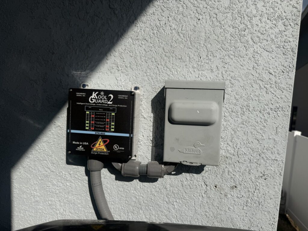 DITEK DTK-KG2 Kool Guard 2 surge protector installed next to the air conditioner disconnect