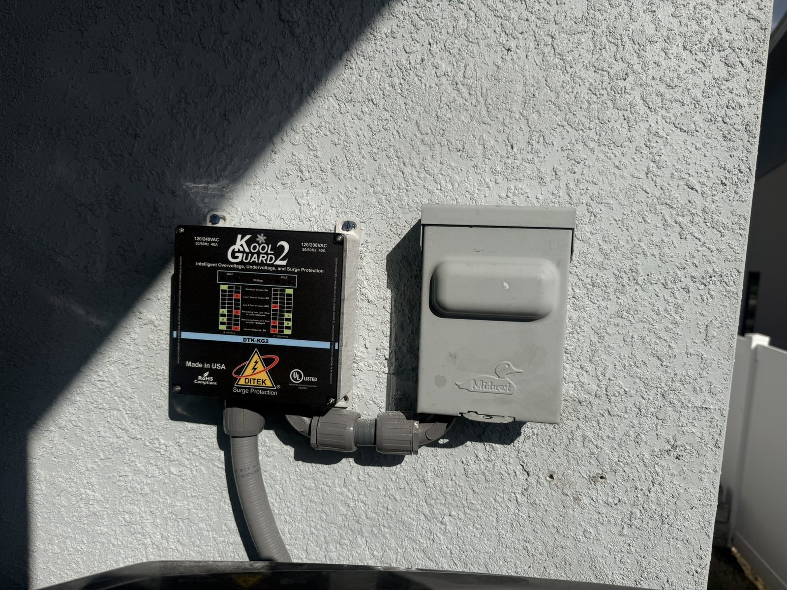 DITEK DTK-KG2 Kool Guard 2 surge protector installed next to the air conditioner disconnect