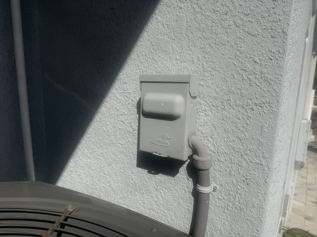 Existing air conditioner disconnect at the outdoor unit before the surge protector was added