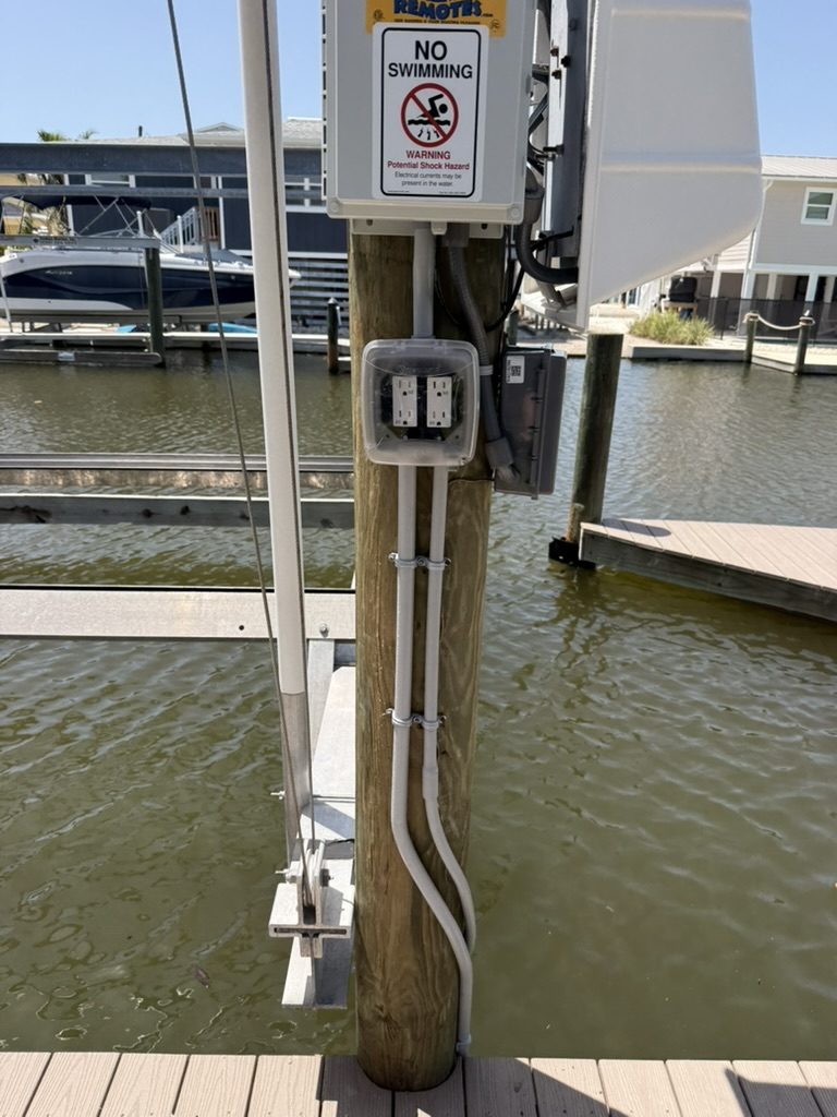 GEM Remotes control, outlets, disconnect and conduit running down the piling to the dock