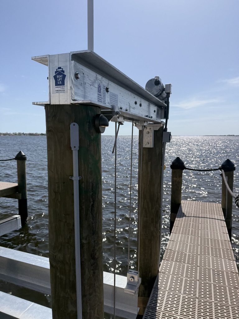 Boat lift beam and motor with conduit and a low-voltage post light