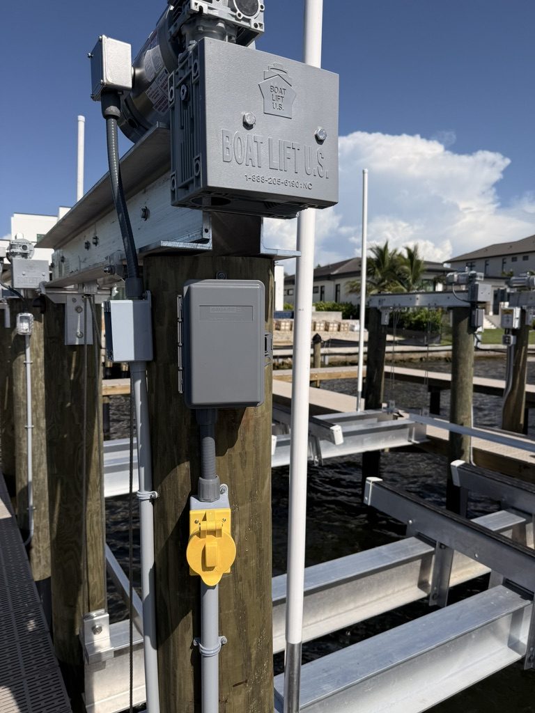 Boat lift motor with the weatherproof 30-amp shore power inlet (yellow cover)