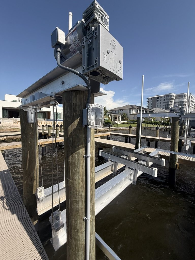 Boat lift motor with conduit and junction boxes