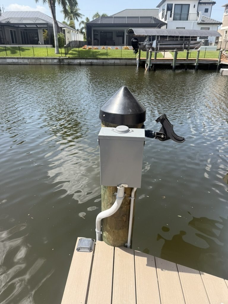 Dock sub panel on a piling with conduit running down to the dock, installed for a future spa
