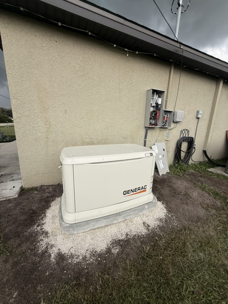 Wide view of the Generac 22 kW generator, concrete pad and the transfer switch on the exterior wall