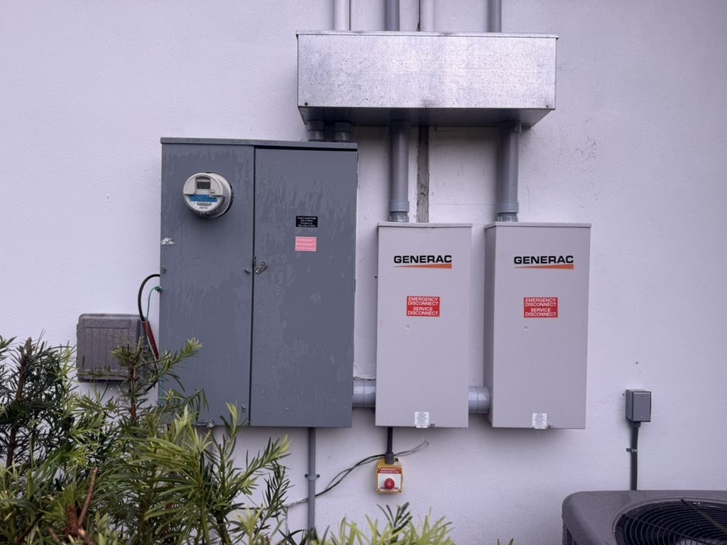 Meter main with two Generac 200-amp automatic transfer switches and the wireway above