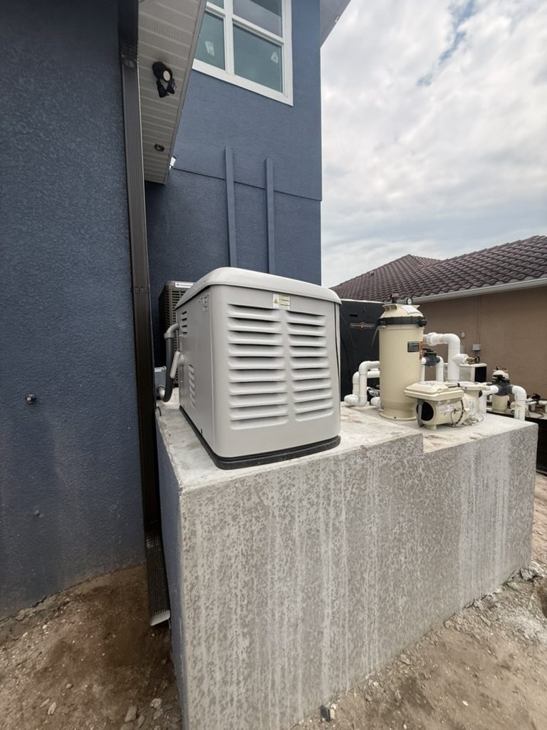 Generator on the raised concrete pad at the rear of the home, with pool equipment on the same pad