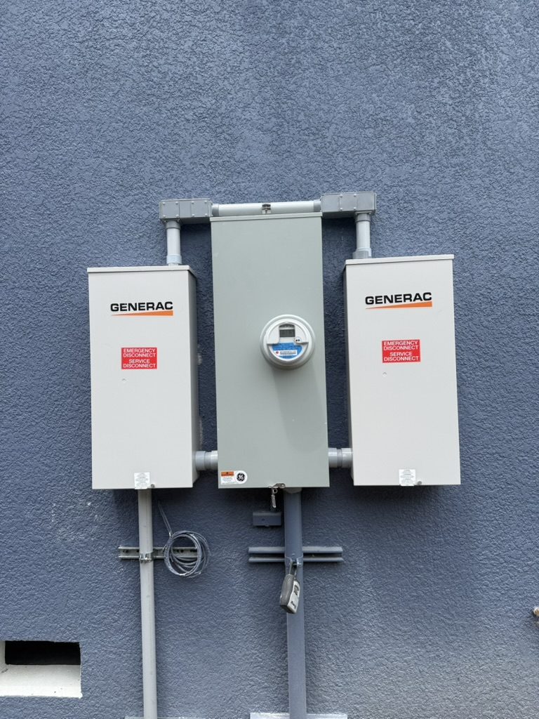 Two 200-amp Generac transfer switches, one on each side of the outdoor meter, joined by conduit