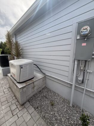 Generator on the raised concrete pad with the meter main and conduit run