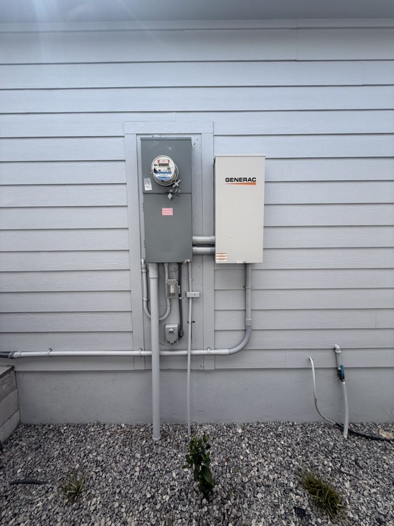 Generac automatic transfer switch installed beside the meter main on a Fort Myers home