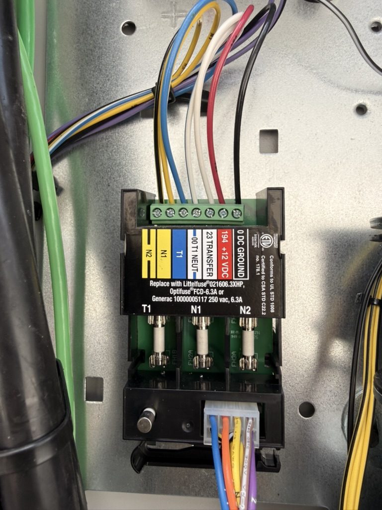 Inside the Generac automatic transfer switch, showing the terminal and fuse block