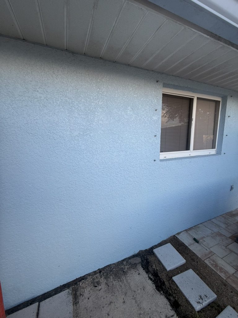 Bare exterior wall at the sub panel location before the work