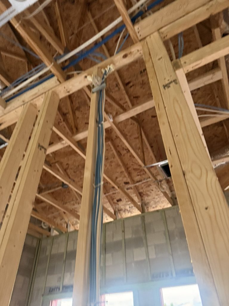 Cable bundle run up a stud to the ceiling trusses
