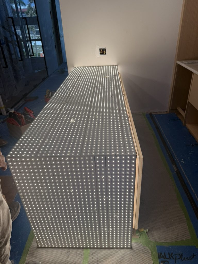 Aspect LED lighting sheets powered on over the custom countertop base before the stone top was set