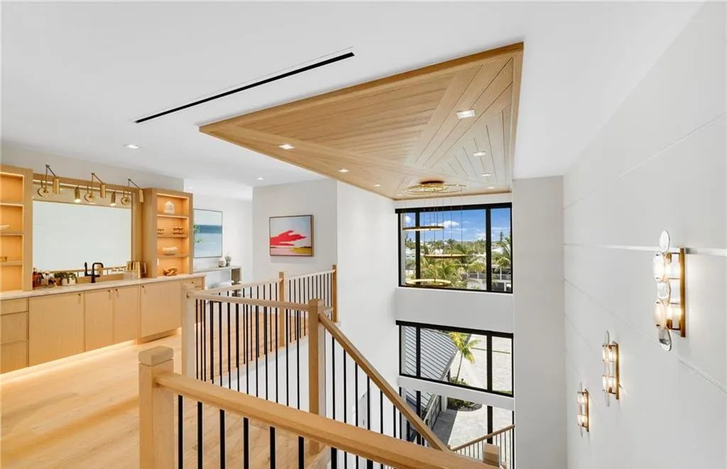 Stair landing with LED-lit bar shelving and toe kick lighting under a wood ceiling